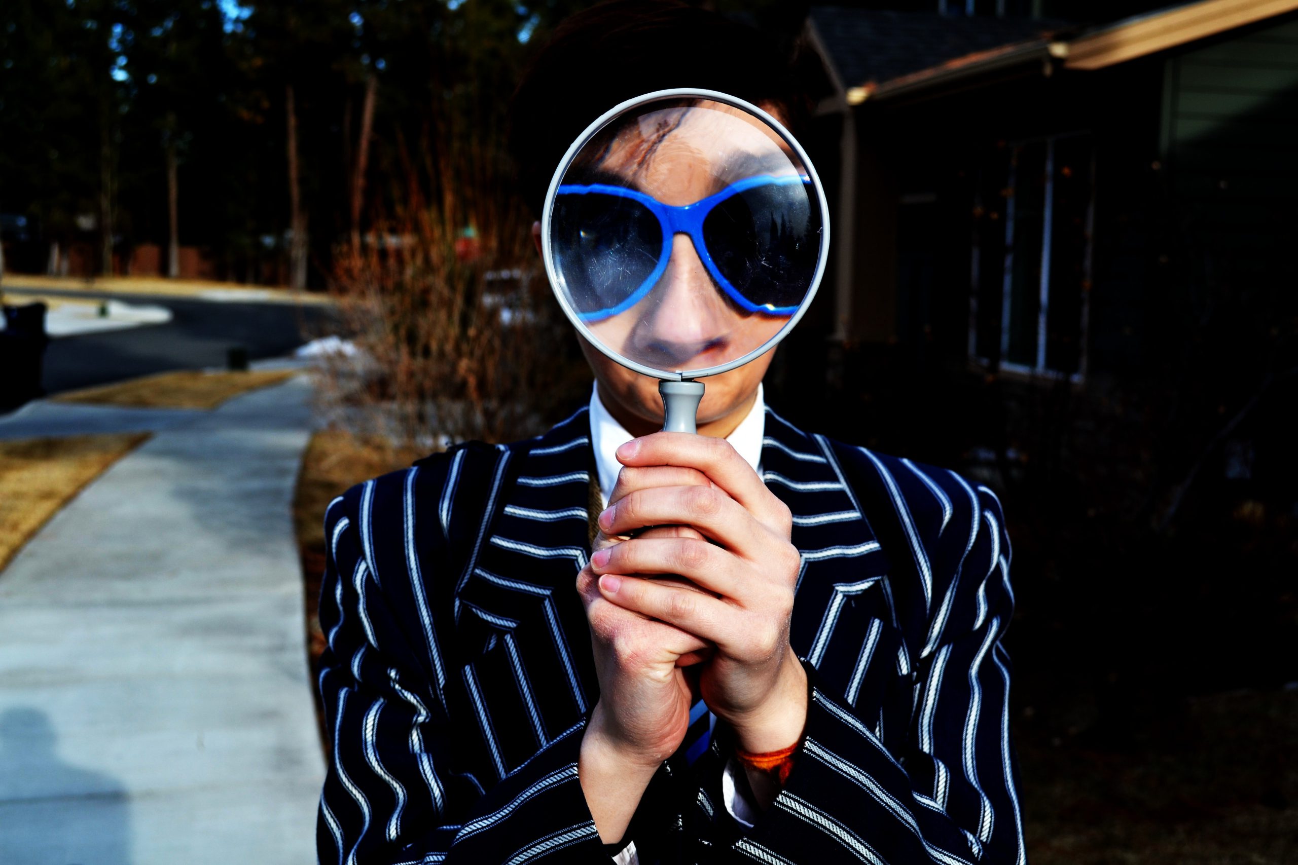 A staff recruiter looking through a magnifying glass.