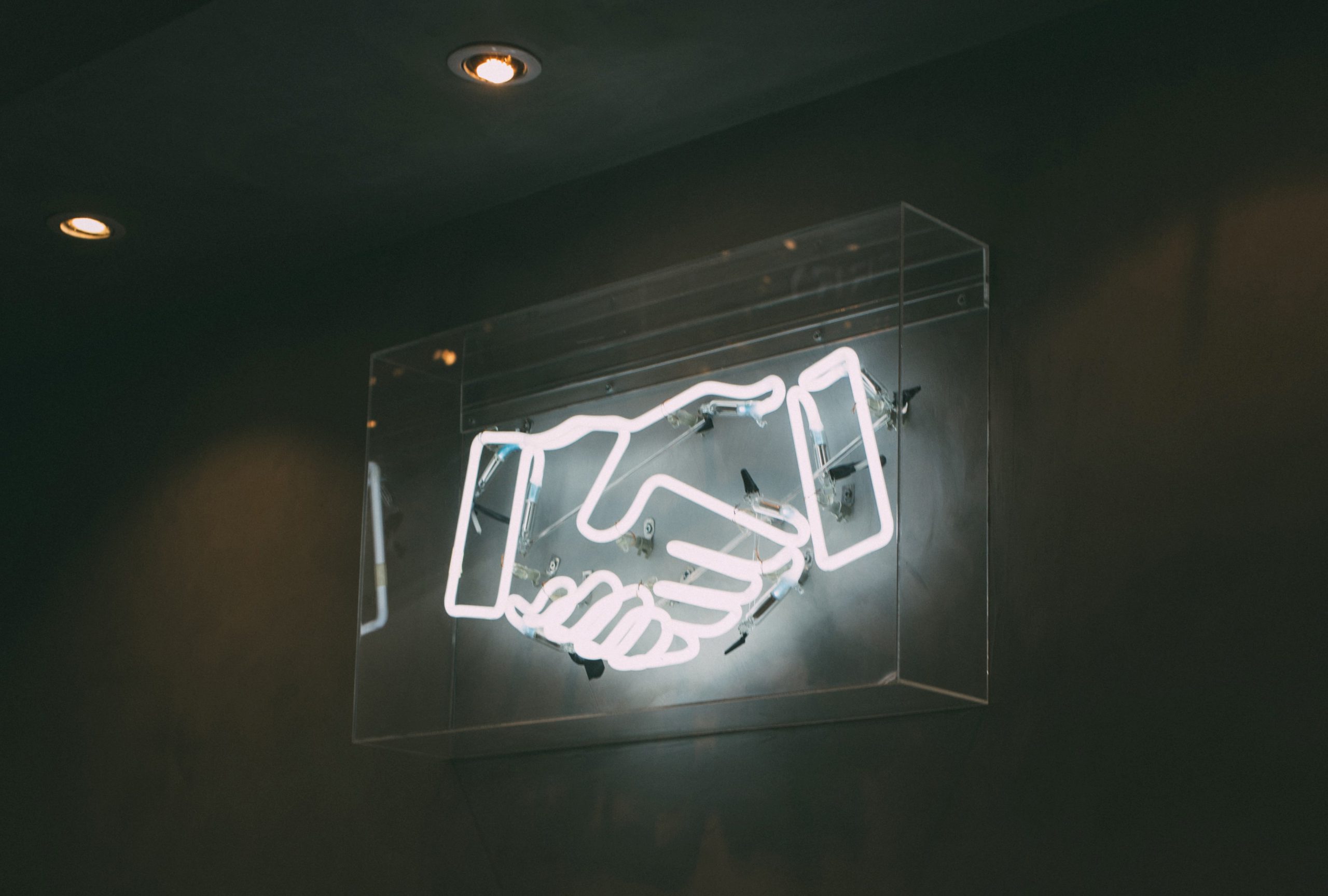 Neon sign depicting a handshake